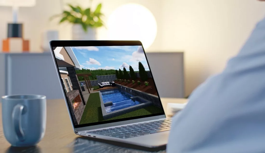 3D backyard and pool design displayed on a laptop