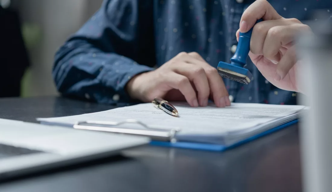 Permit document being stamped for approval
